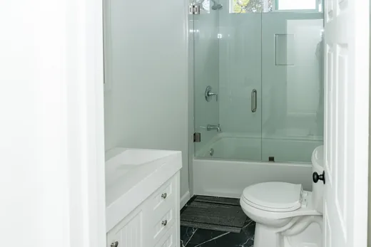 Bathroom with a tub and glass shower doors