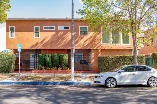 Street view of the terracotta two-story duplex at 6002-6004 S Denker